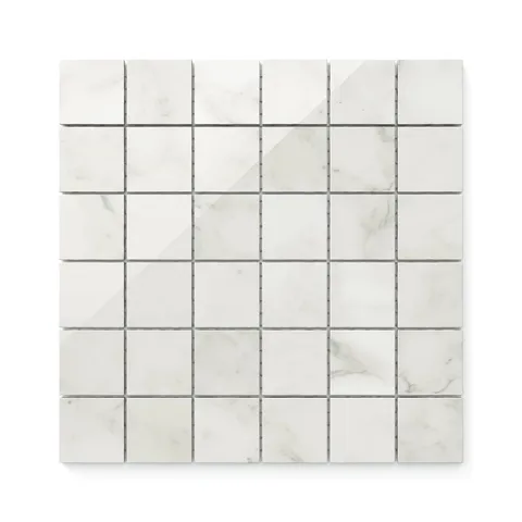 White polished Carrara Bianco 2x2 mosaic marble look tiles with light grey veining, offering a classic and versatile design for timeless elegance.