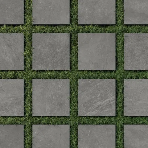 Contemporary 12x12 dark gray porcelain outdoor pavers with a matte finish, 2cm thickness, and grip, elegantly spaced on lush green grass for a modern landscape design.
