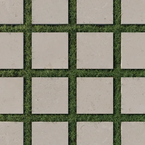 Square porcelain pavers in a natural dune-beige finish, featuring a 12x12 size and 2cm outdoor grip, arranged on lush green grass for a matte-textured outdoor elegance.