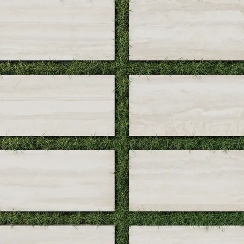 Modern 12x24 soft beige toned porcelain pavers with a 2cm outdoor grip matte finish, elegantly arranged over green grass for a clean outdoor aesthetic.