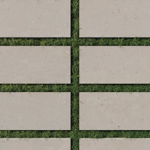 12x24 dune-beige porcelain tiles with a 2cm thickness and matte grip finish, arranged on lush green grass, perfect for stylish outdoor pathways.