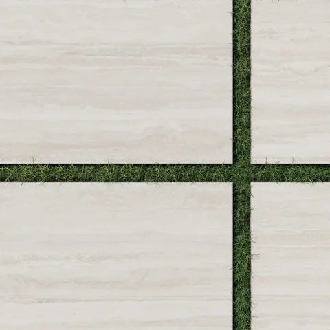 Close-up of Wren 24x36 grip porcelain 2cm paver tiles in oat, showcasing light cream tones with soft striations, arranged with lush green grass for a refined outdoor look.