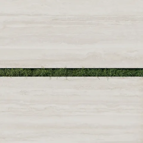Close-up of Wren 24x48 2cm matte porcelain oat tiles in a soft beige tone, separated by strips of lush green grass for a harmonious outdoor design.