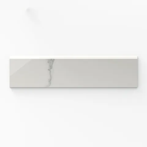 Leona Calacatta 3x12 bullnose tile in a polished finish, showcasing a soft white marble look with delicate gray veining.