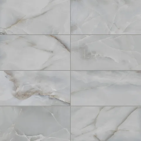 Astrid 12x24 matte porcelain tile in Slate, showcasing soft slate blue tones with subtle white and golden veining for a sophisticated marble-like finish.