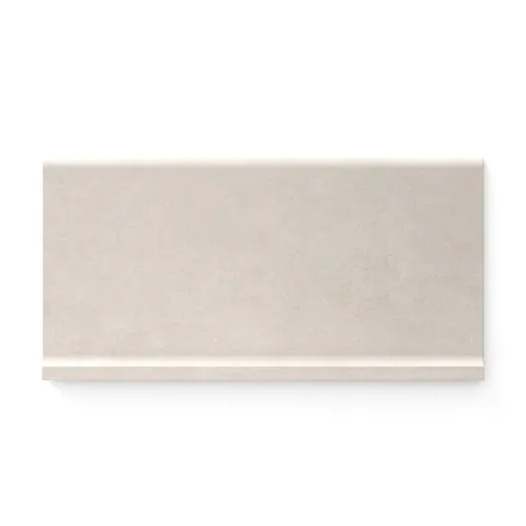 Soft dune-toned Wyatt 6x12 matte porcelain cove base tiles, offering a seamless and elegant finish for modern design transitions.