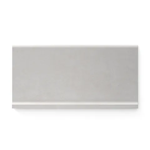 Subtle fog-toned Wyatt 6x12 matte porcelain cove base tiles, offering a soft, versatile finish perfect for clean and contemporary designs.