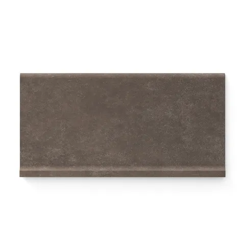 Rich espresso-hued Wyatt 6x12 matte porcelain cove base tiles, bringing a warm, sophisticated finish to modern and elegant interiors.
