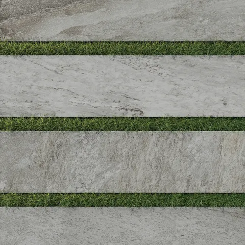 Carter Fossil 12x48 Matte Porcelain Pavers in grey tones with realistic stone textures, bordered by lush green grass for a natural outdoor aesthetic.