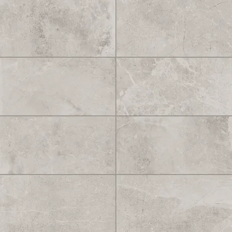 Elegant 12x24 matte porcelain tiles in light taupe hues, accented with gentle veining, perfect for creating a bright and airy aesthetic.