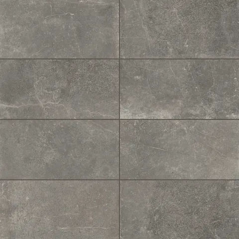 Rich 12x24 matte porcelain tiles in deep smoky gray tones, highlighted with natural veining for a bold and contemporary design.