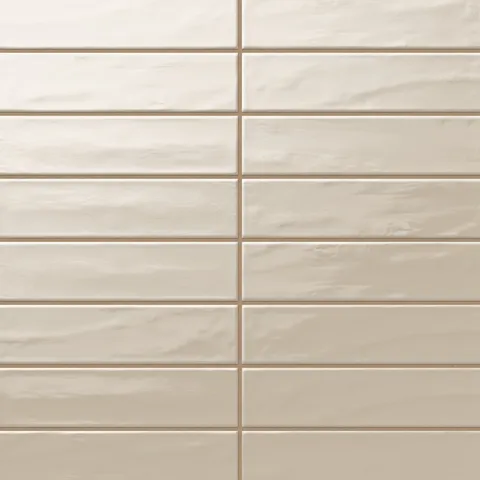 Palmer 3x12 glossy porcelain tile in sand, displaying a soft beige tone with a reflective finish for walls or backsplashes.