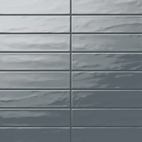 Palmer 3x12 glossy porcelain tiles in blue-grey, featuring a smooth, reflective finish and subtle wavy texture for a modern look.