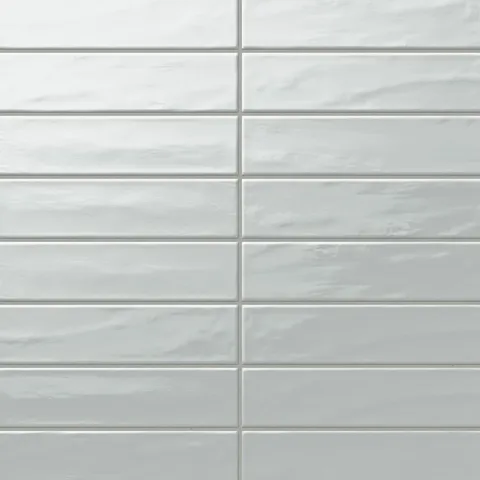 Palmer 3x12 glossy porcelain tile in Mint, featuring a soft green hue and a polished surface.