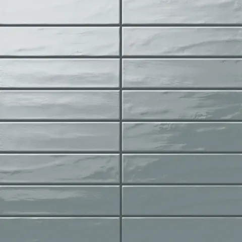 Palmer 3x12 glossy porcelain tile in a soothing eucalyptus green shade, showcasing a subtle texture and shine.