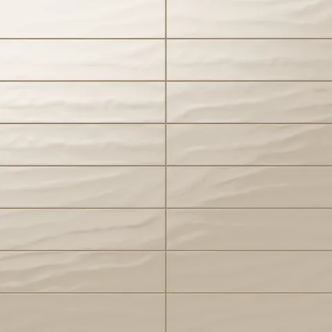 Palmer 6x24 glossy porcelain tile in sand, showcasing a warm beige tone perfect for inviting interior designs.