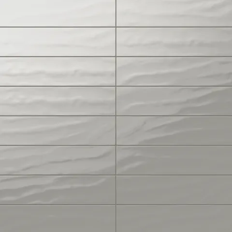 Palmer 6x24 glossy porcelain tile in olive, showcasing a smooth wavy texture with a soft greenish-grey sheen.