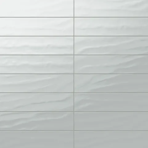 Palmer 6x24 glossy porcelain tile in mint, showcasing a smooth surface with delicate green hues and wavy texture.