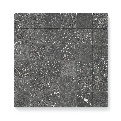 Close-up view of Sloane Charcoal 2x2 matte tiles, showcasing a refined speckled surface with intricate details and a contemporary dark tone.