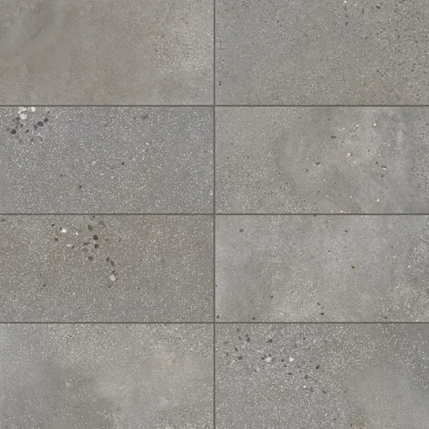 Sloane 12x24 matte porcelain tile in Pebble, featuring a medium-gray tone with speckled details, ideal for adding texture and depth to modern interiors.