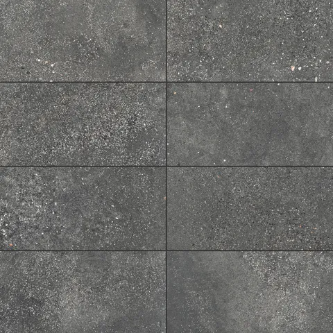 Sloane 12x24 matte porcelain tile in Charcoal, showcasing a textured surface with subtle speckling, ideal for creating a modern, industrial aesthetic.