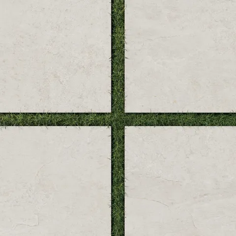 Dawson 24x24 Grip Porcelain 2cm Paver Tile in Alabaster, set with green grass joints, showcasing its natural stone texture and outdoor suitability.