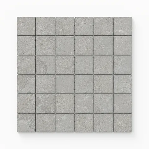 Matte porcelain mosaic tiles in a cool ash gray tone, featuring a 2x2 cross-cut design that combines modern simplicity with a natural stone-inspired texture.