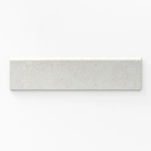 A 3x12 soft white matte porcelain bullnose tile with a subtle cross-cut pattern, ideal for achieving clean, polished trim edges in contemporary designs.