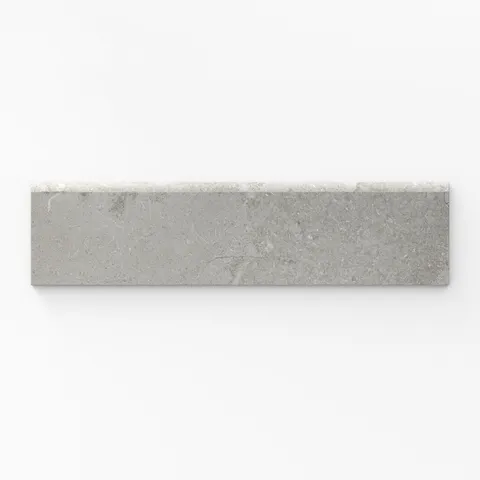 A soft dune taupe matte porcelain bullnose tile, sized at 3x12, featuring a cross-cut design, perfect for creating smooth, polished edges with a natural, elegant finish.
