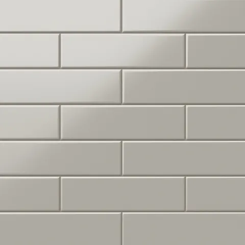 Polly Grey 3x10 satin ceramic tiles deliver a subtle matte finish in a soft grey tone, perfect for creating a modern and versatile design.