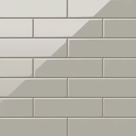 Polly Grey 3x10 glossy ceramic tiles combine a sleek reflective surface with a neutral tone, perfect for modern backsplashes or sophisticated feature walls.