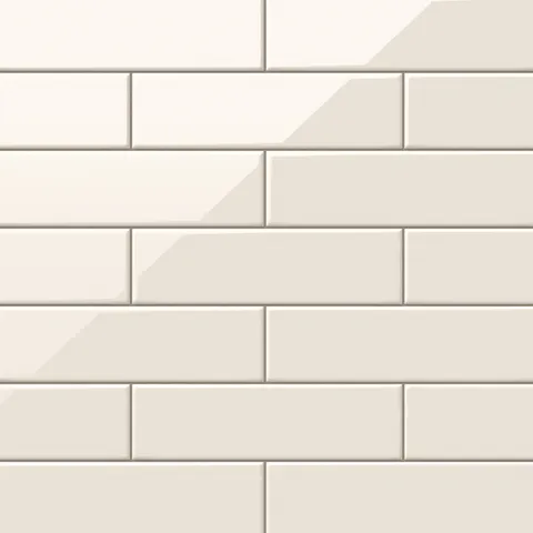 Polly Cream 3x10 glossy ceramic tiles offer a warm, sophisticated tone with a smooth reflective finish, perfect for creating timeless backsplashes or elegant bathroom walls.