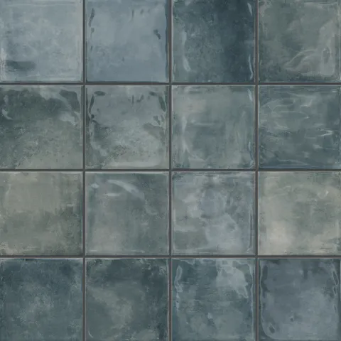 Lilah Marine 6x6 glossy tiles, featuring varying shades of blue with a textured, reflective surface, creating a vibrant, marine-inspired look.