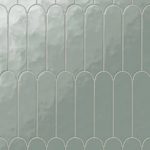 Featuring a fishscale pattern, these glossy green tiles evoke the calm of the coast, making them per