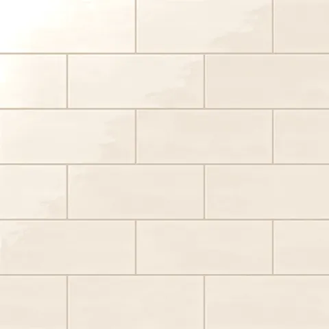 Soft cream 4x10-inch ceramic subway tiles with a glossy finish, arranged in a staggered brick pattern