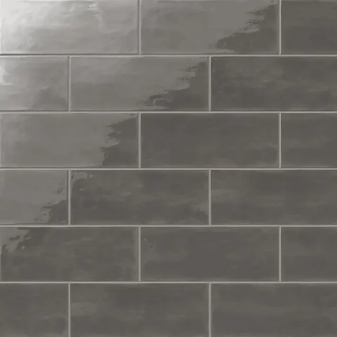 Chic dark gray 4x10-inch glossy ceramic tiles in a subway layout, adding depth and sophistication to modern interiors