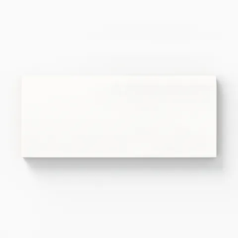 Glossy 3x6-inch white bullnose tile with a smooth finish, offering a sleek and modern aesthetic for elegant spaces