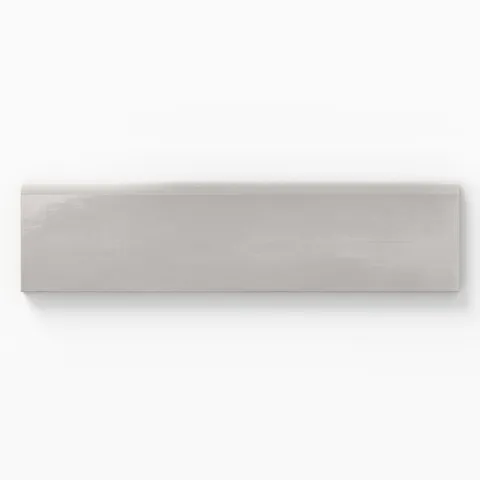 Glossy 3x10 bullnose tile with a soft gray hue, designed for smooth edging in sophisticated tile layouts