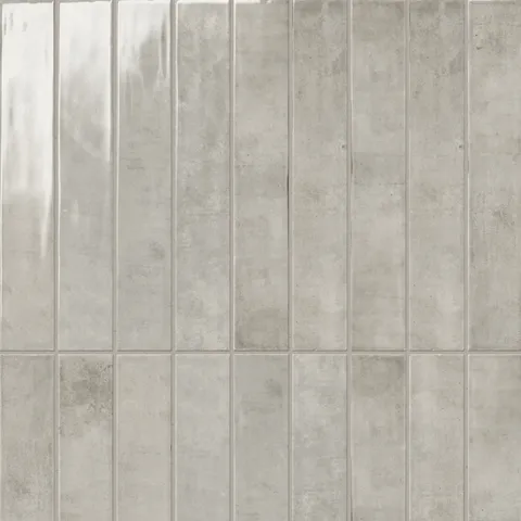 Jaden Dove 2.5x16 gloss tiles, featuring a sleek gray finish with a subtle stone-like texture, perfect for refined and contemporary spaces.