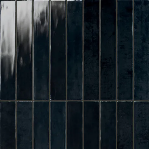 Deep navy 2.5x16 gloss tiles with a reflective finish, perfect for creating a bold and sophisticated statement in any interior.