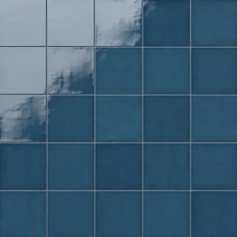 Mikayla ceramic 5x5 square tiles in a bold blue tone, featuring a smooth glossy finish with light reflections for a vibrant, handmade look