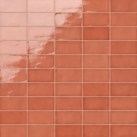Vibrant Mikayla coral-orange ceramic subway tiles with a glossy finish, perfect for adding warmth and character to interiors