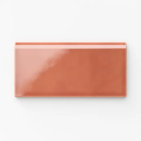 Glossy Mikayla ceramic bullnose tile in a vibrant orange-pink tone, ideal for adding warmth and character to edges and trims
