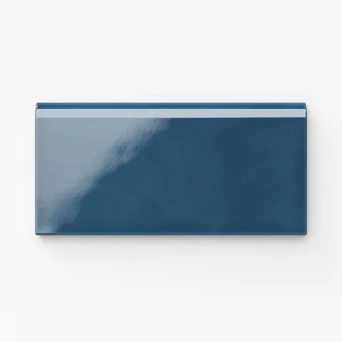 Glossy Mikayla ceramic bullnose tile in a rich cerulean-blue hue, offering a refined edge detail perfect for seamless and elegant finishes