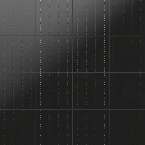 Kira 12x12 satin ceramic tiles showcasing a sleek black surface with vertical rows of delicately recessed gold dots for modern elegance
