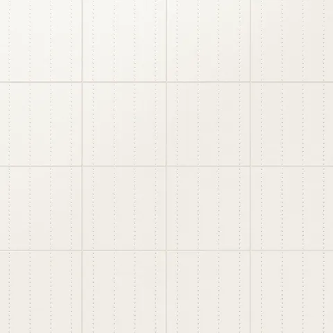 Kira 12x12 satin ceramic tiles with a clean white surface and vertical rows of subtly depressed gold dots for a refined aesthetic