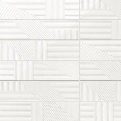 Textured Kinsley Cloud Deco 4x16 tile in a glossy white finish, featuring intricate geometric patterns.