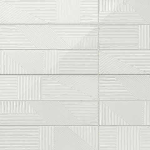 Kinsley 4x16 glossy ceramic tiles in fog deco, featuring geometric textured patterns for a chic and dynamic design aesthetic.