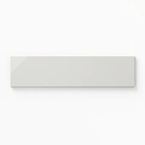 Kinsley 4x16 glossy bullnose tile in fog, offering a sleek finish and rounded edge for a refined touch.