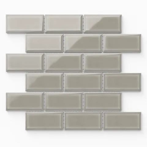 Maggie taupe mosaic porcelain tile in a 2x4 beveled brick pattern with a glossy finish, offering subtle sophistication
